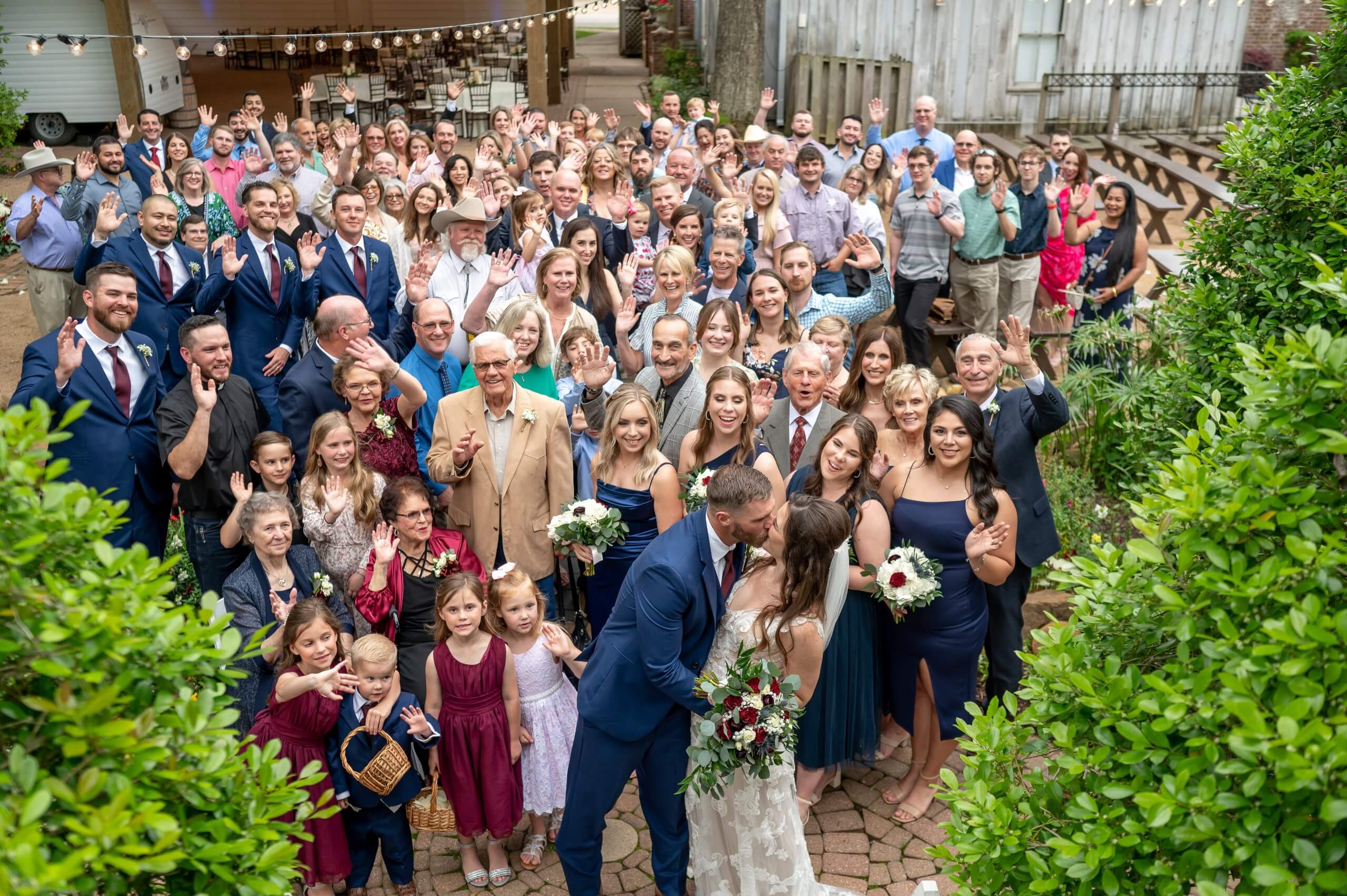 Wedding guests pose for an outdoor party photo