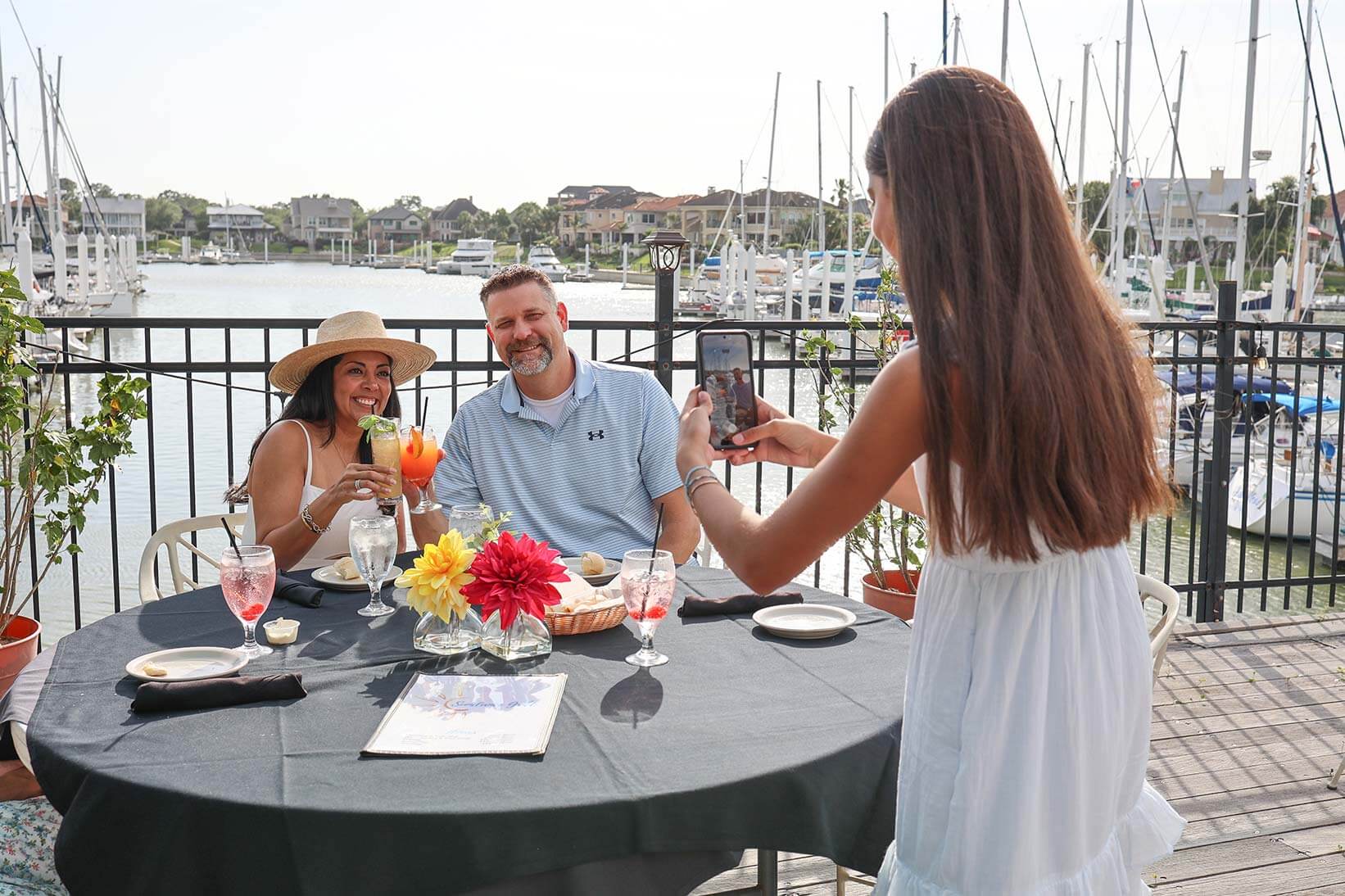 A couple having their picture taken while eating near Bay Area Houston