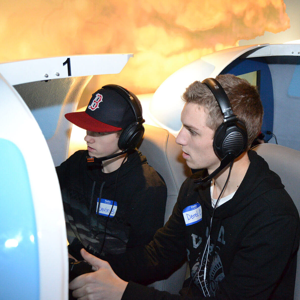 Teen boys focus on a flight simulation during a summer camp program hosted at the Lone Star Flight Museum in the Bay Area of Houston, TX.
