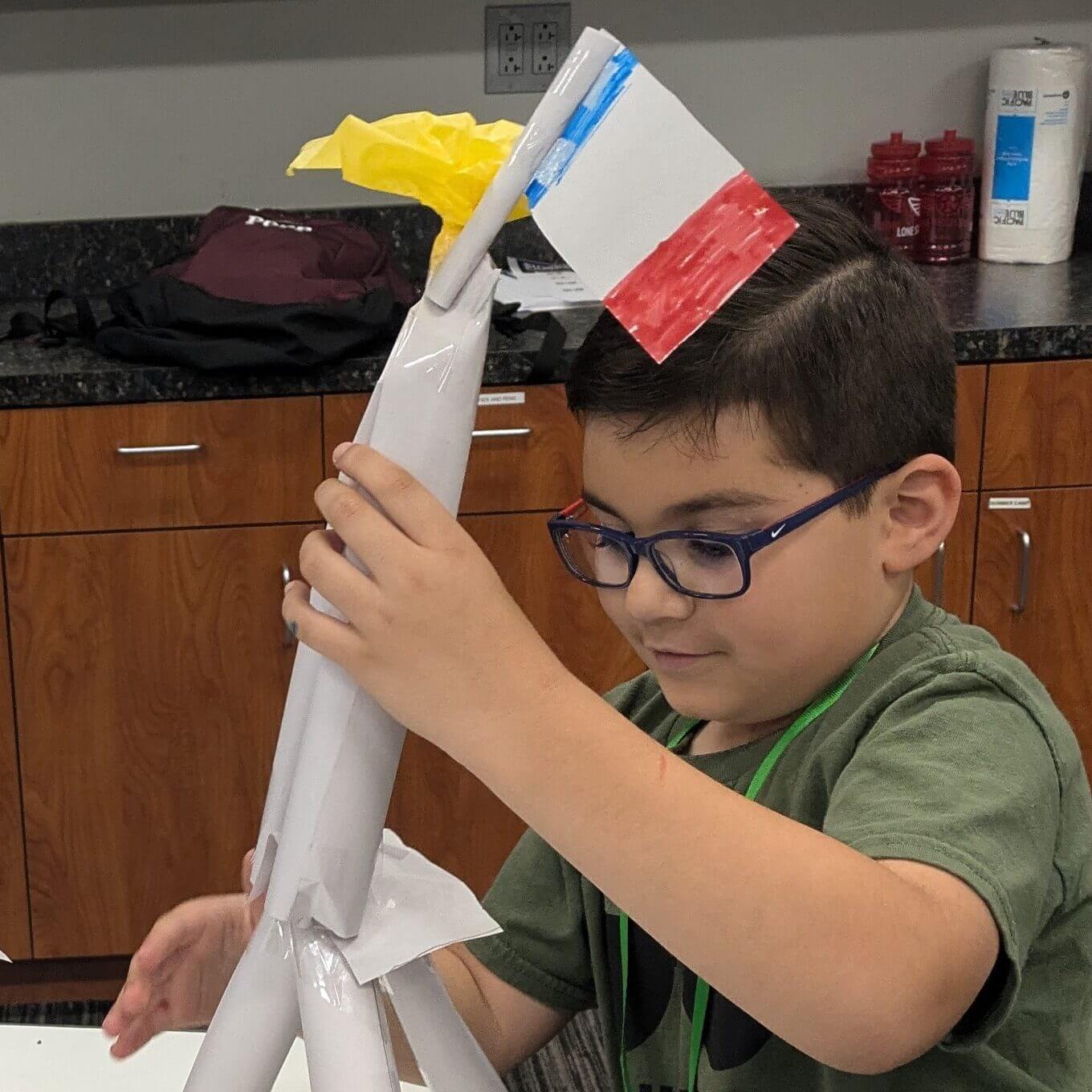 A boy designs a rocket ship during a one-day summer camp session hosted at the Lone Star Flight Museum in Houston, TX.