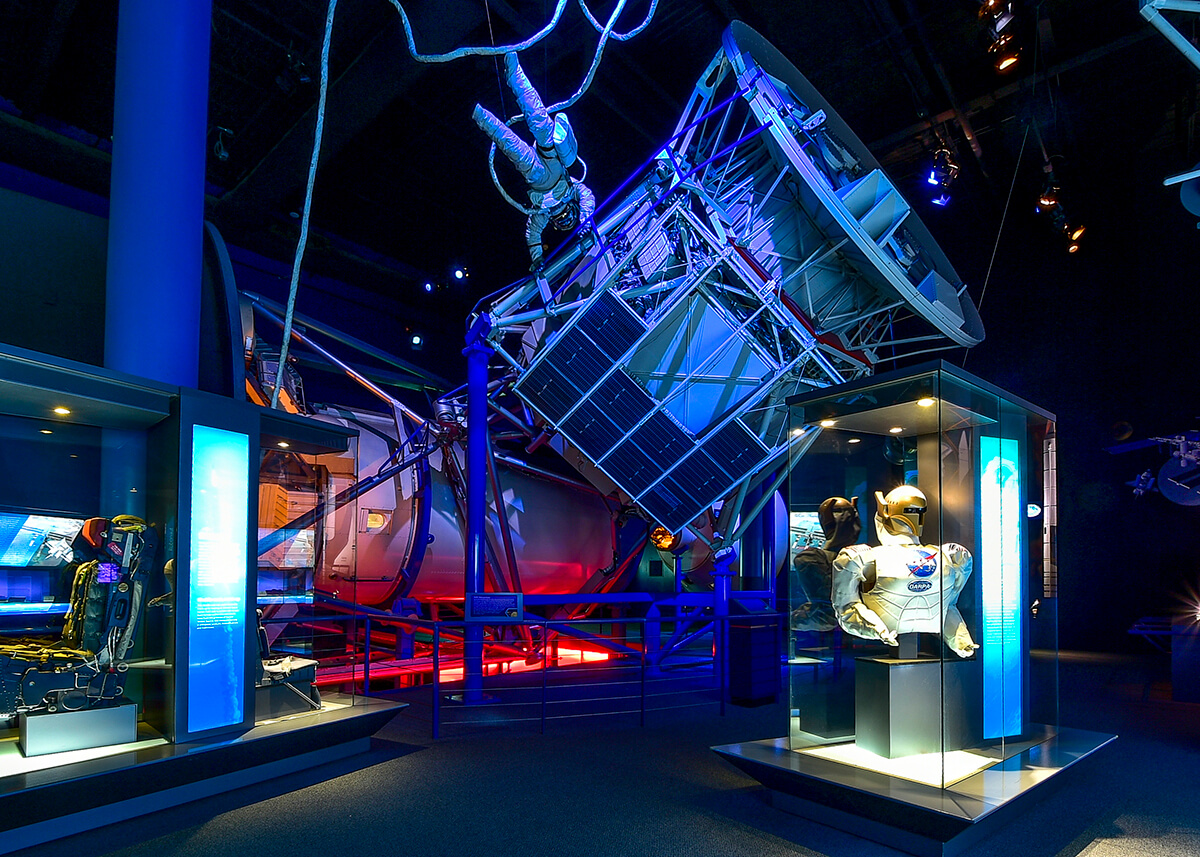 A starship available to be seen at the Space Center Houston is featured an exhibit lit by blue light.