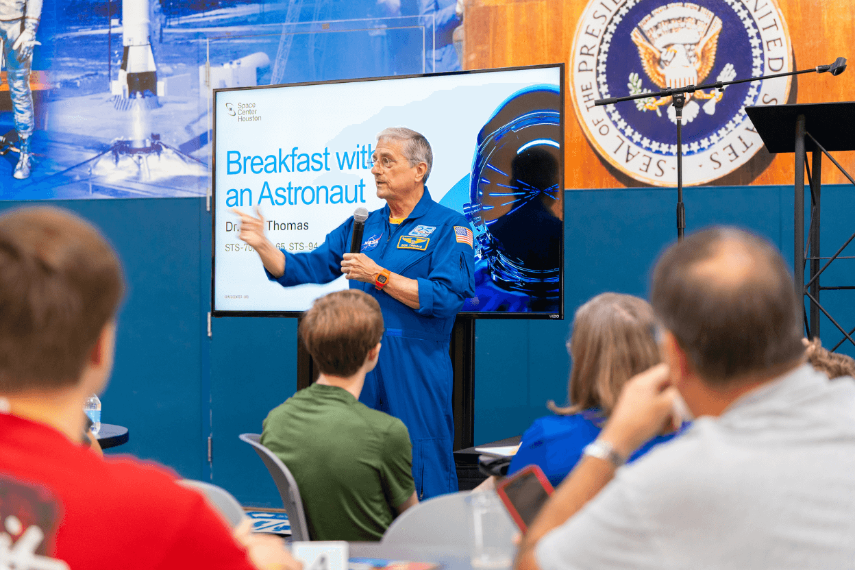 Astronaut Dr. Don Thomas presenting in the Mission Briefing Center.
